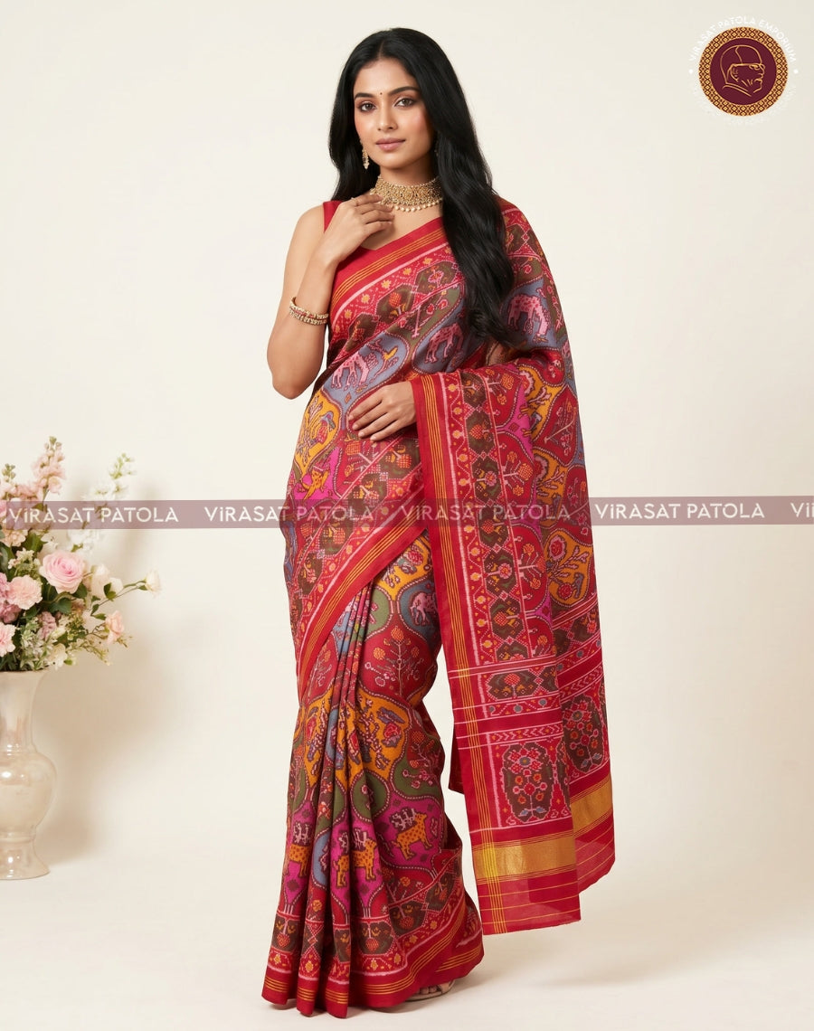 Traditional patola saree with red border and pallu, multicolour elephant motifs on blue