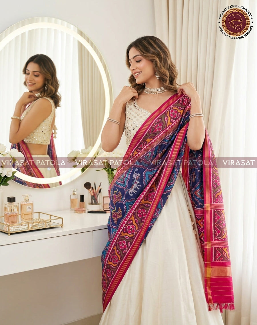 Blue patola dupatta draped over shoulder, animal and floral motif with pink trim