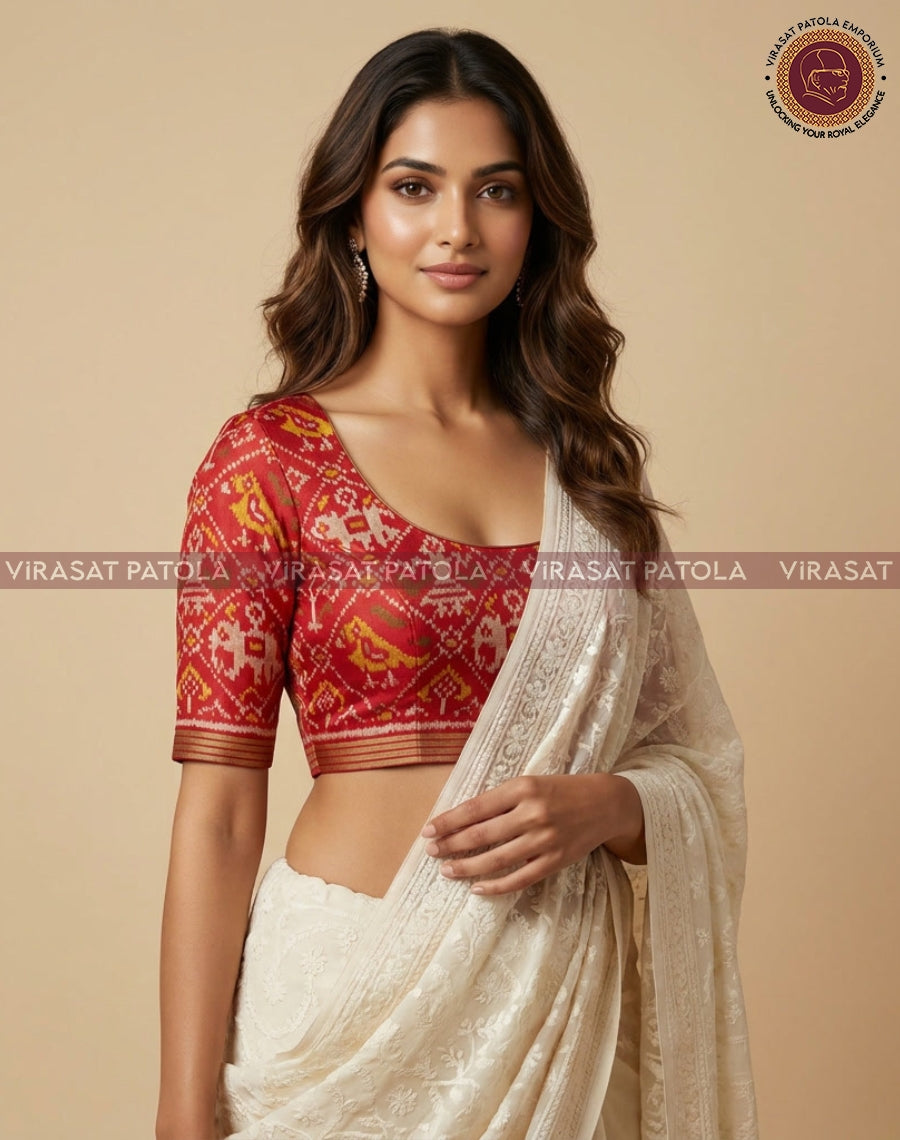 Red traditional patola blouse piece, elbow-length sleeves, round neckline