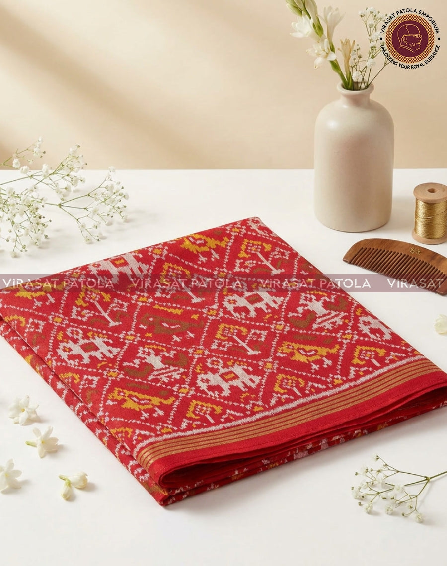 Red patola blouse fabric piece with woven geometric motifs and border