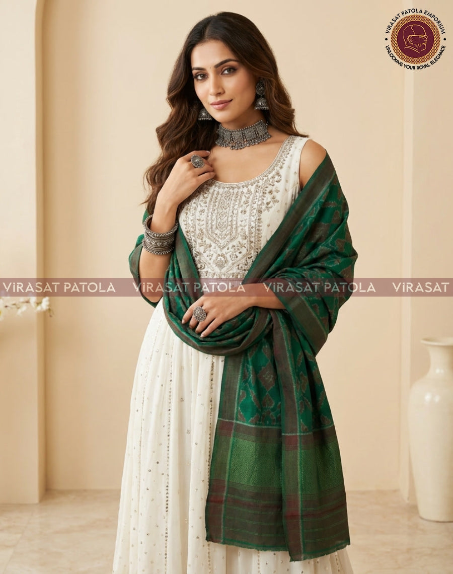 Green patola shawl in draped style with jacquard motifs and wide border.