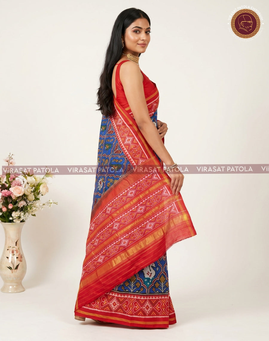 Blue patola saree with red pleated border and gold striped pallu, full drape