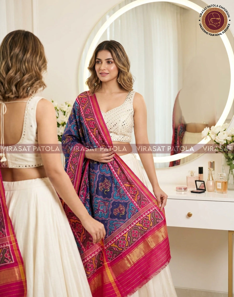 Blue patola dupatta with animal motifs and pink border, draped across torso