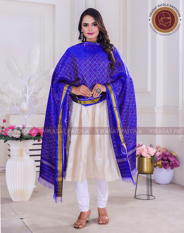 Blue bandhani dupatta with gold border, draped over shoulders