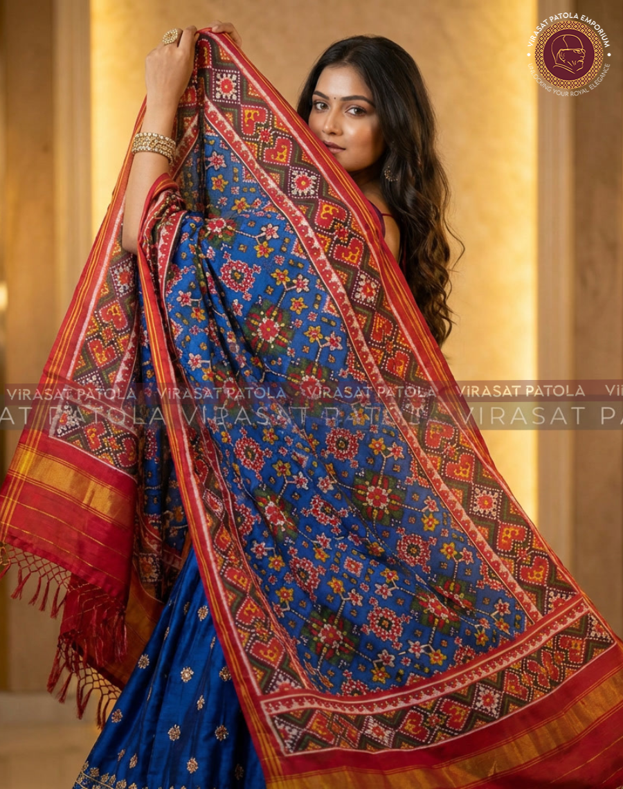 Blue patola dupatta with red border, tassels, and small multicolor motifs
