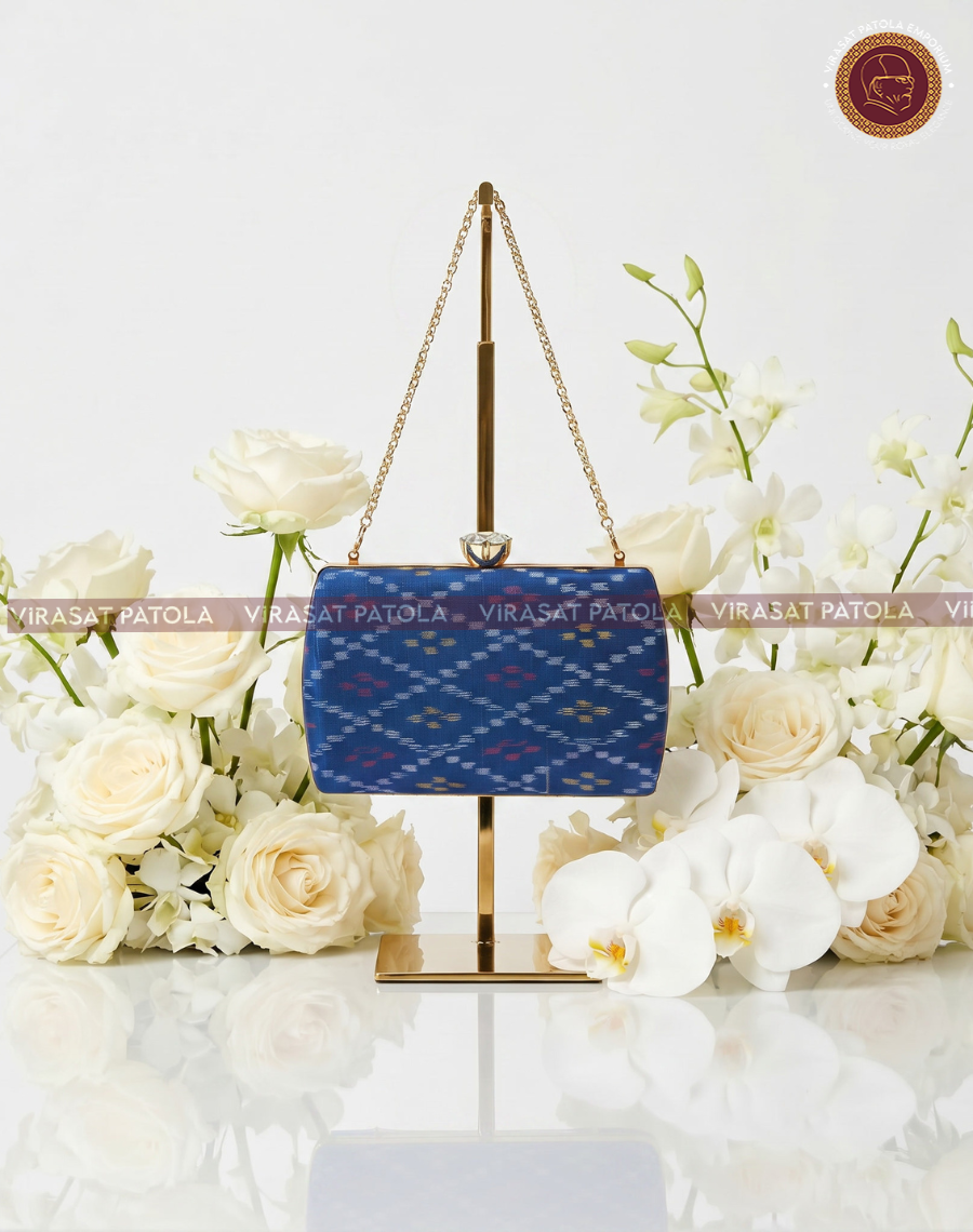 Blue patola bandhani clutch with gold-tone chain strap and clasp