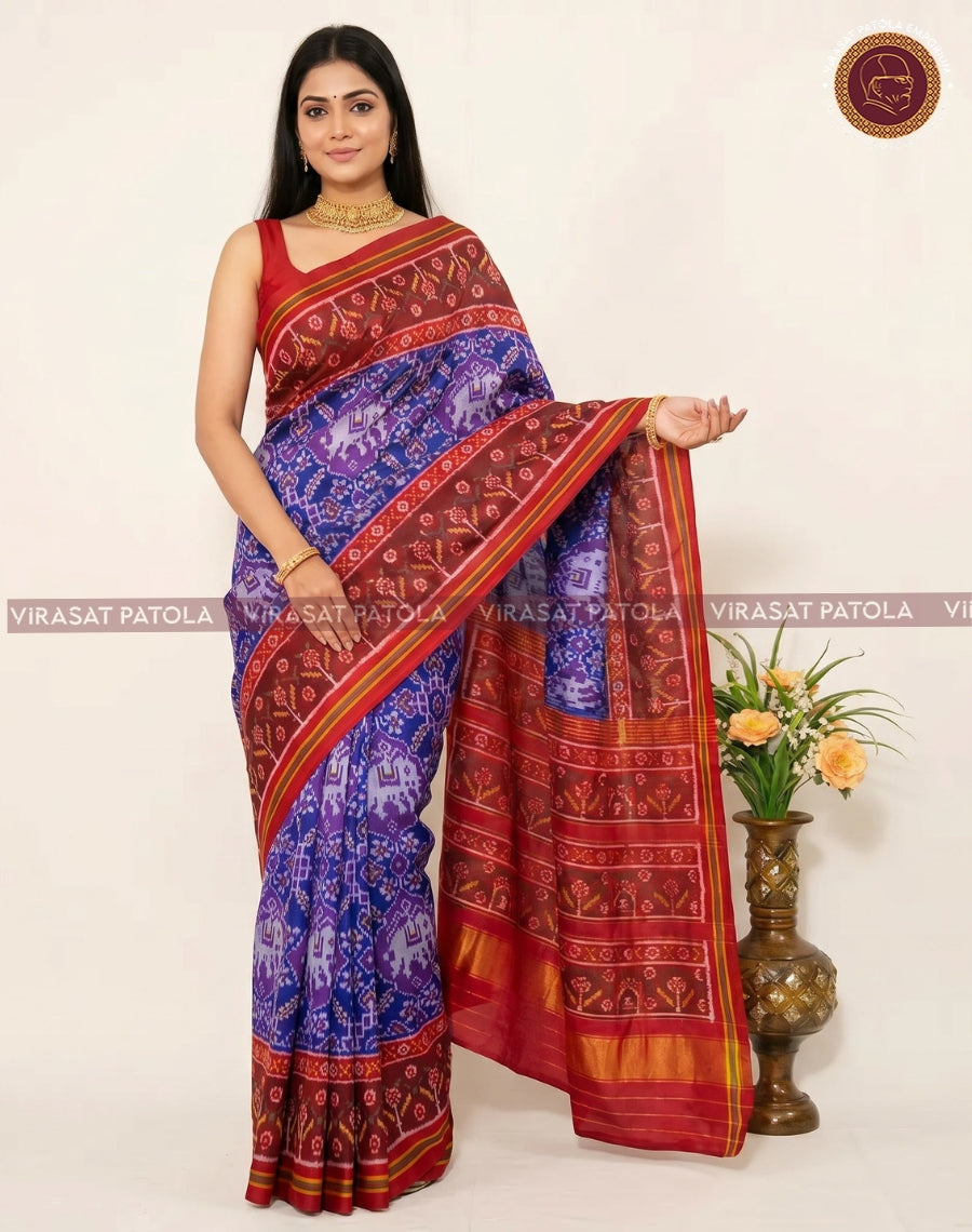 Traditional patola saree with blue body, maroon pallu, and gold striped border