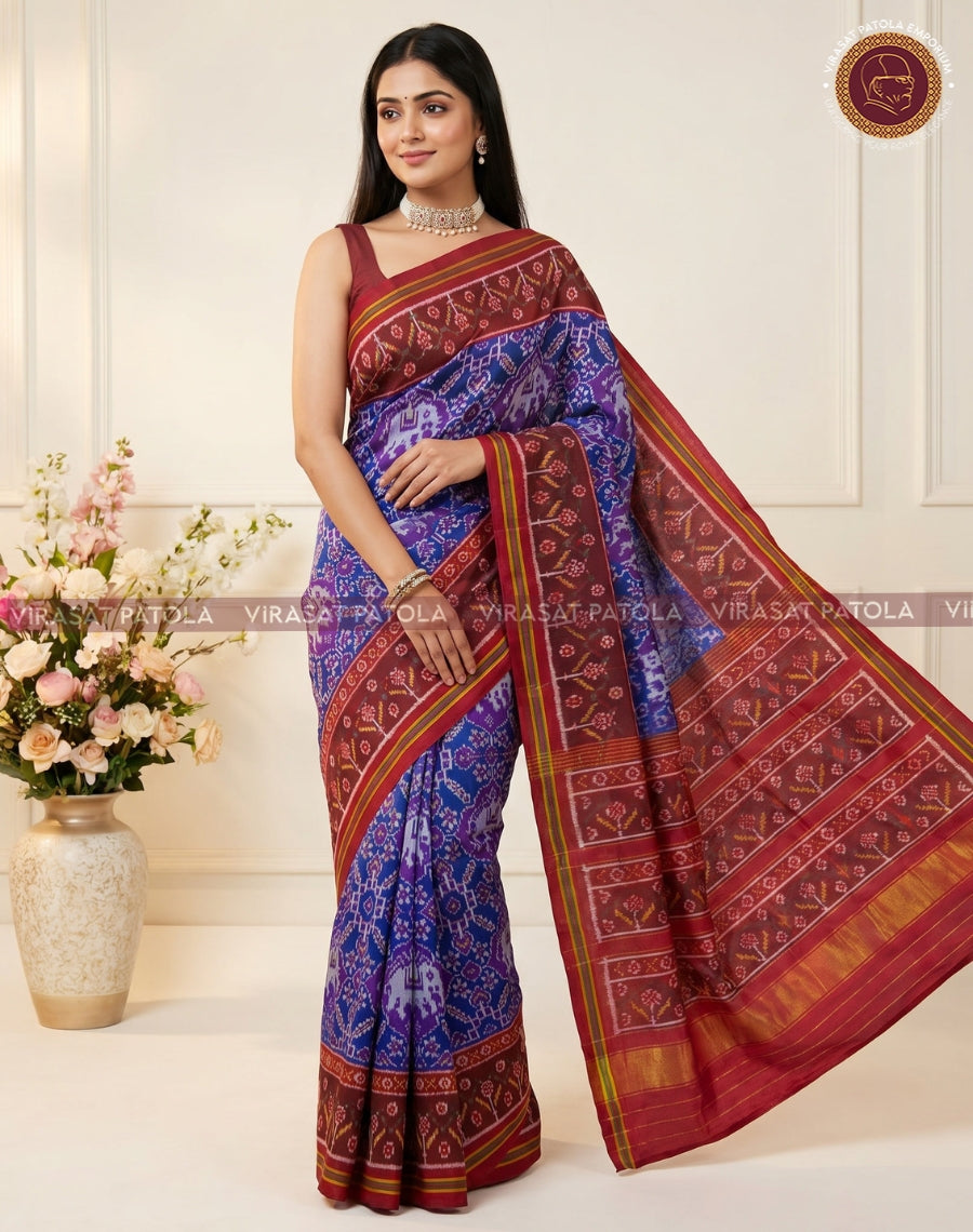 Traditional patola saree with blue patterned pleats and maroon-red pallu with gold border