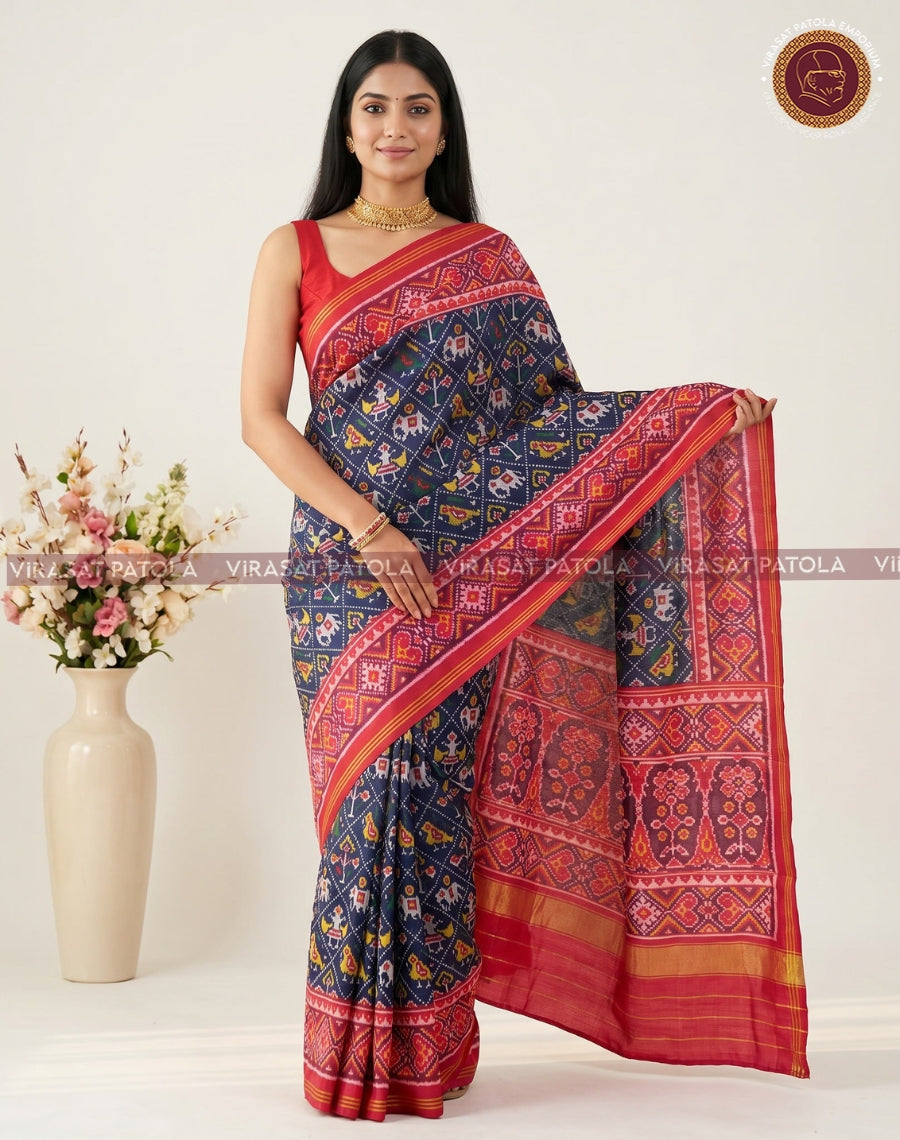 Dark blue Patola saree in pleated drape, red pallu with gold zari edge