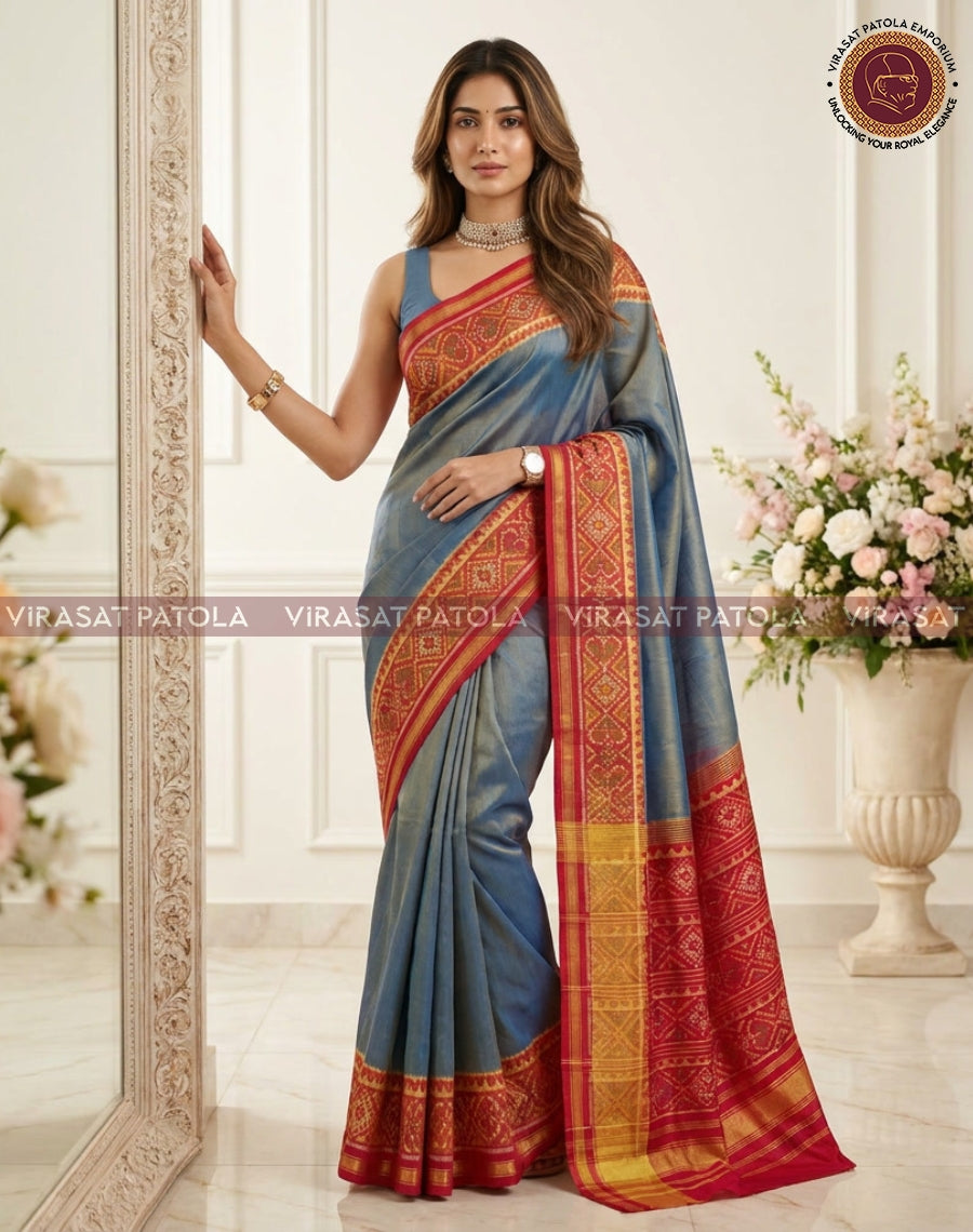 Steel blue traditional saree with red-gold border and woven motif panel