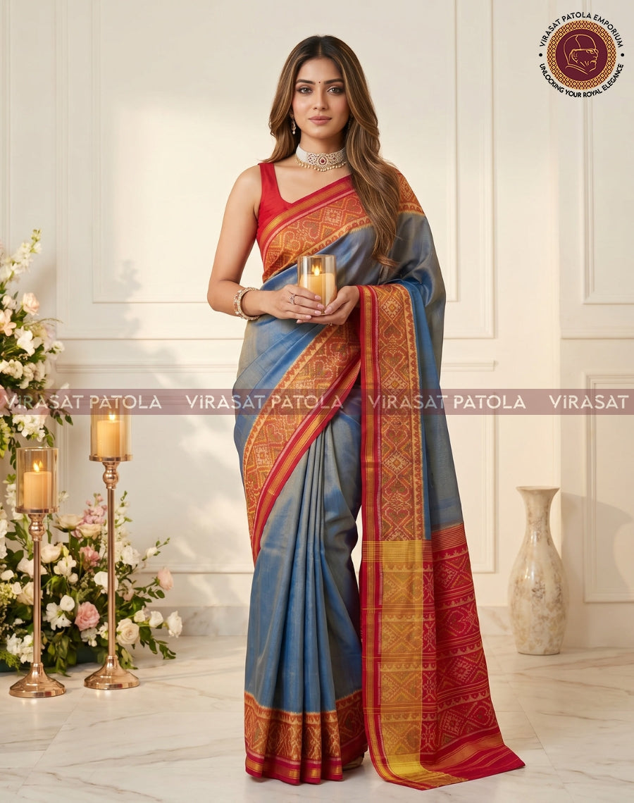 Steel blue saree featuring red-gold woven border and central motif panel