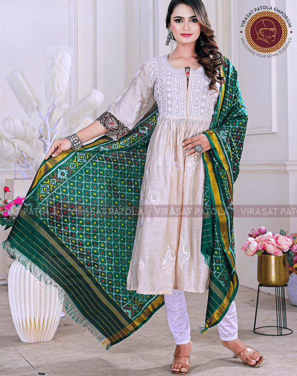 Green bandhani dupatta with multicolor patterned border, draped over shoulder