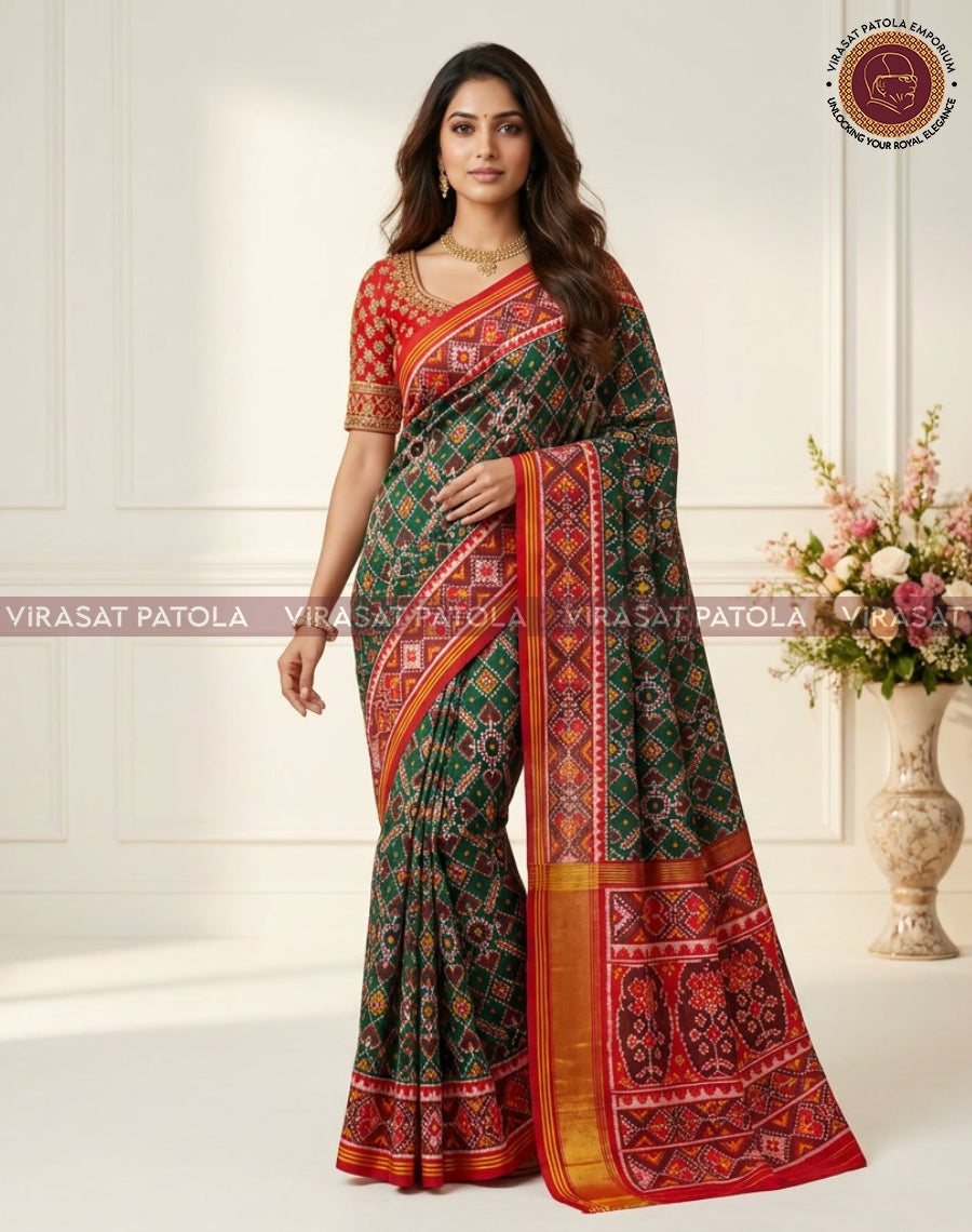 Green saree draped in full length, bold red-orange border with gold zari and motifs