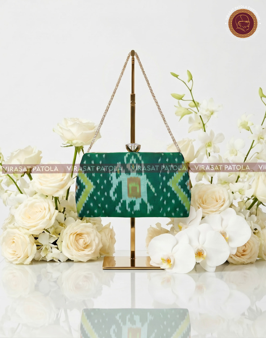 Green Nari Kunjar clutch with gold chain and ikat pattern front
