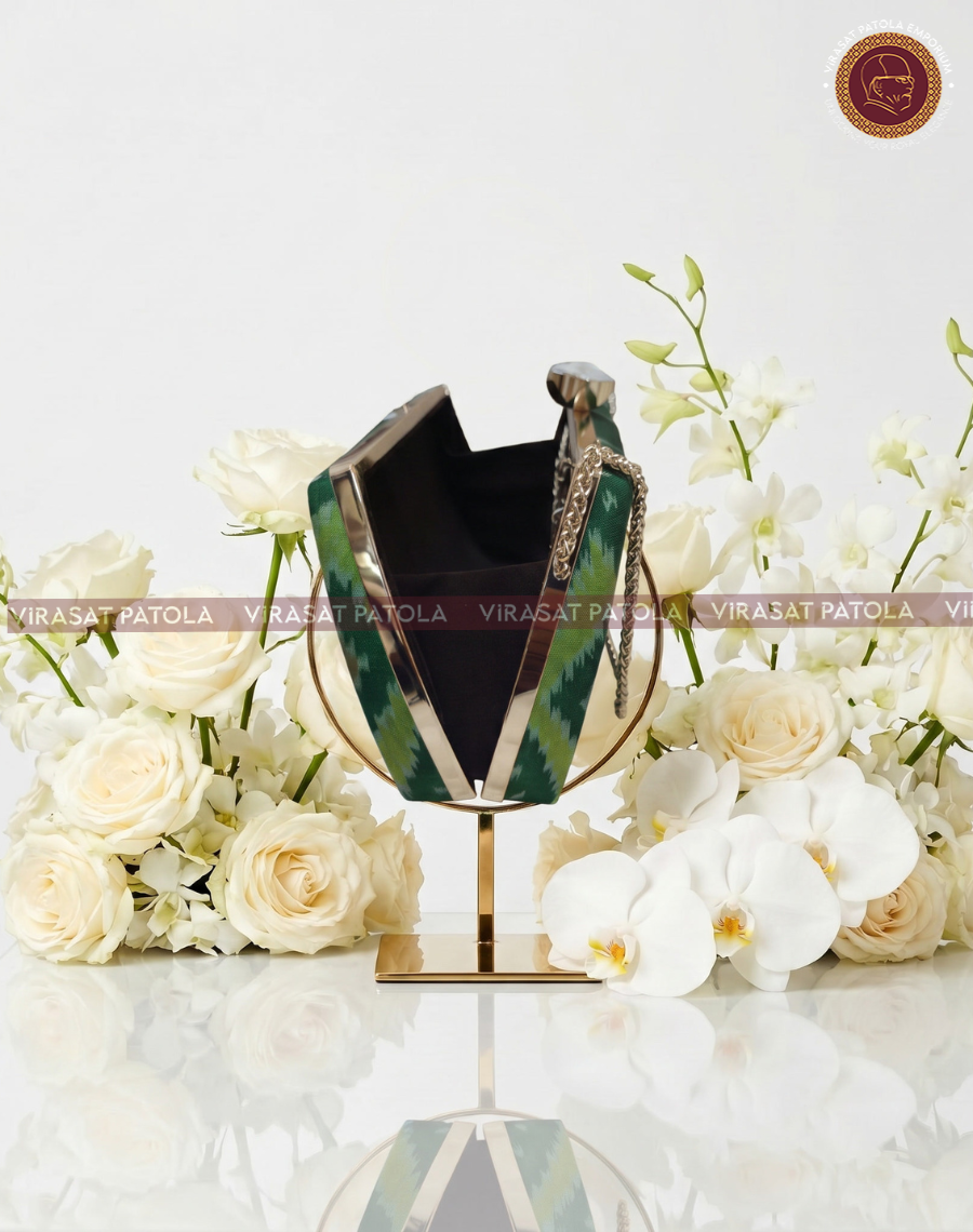 Green Nari Kunjar clutch open, showing black interior and patterned sides