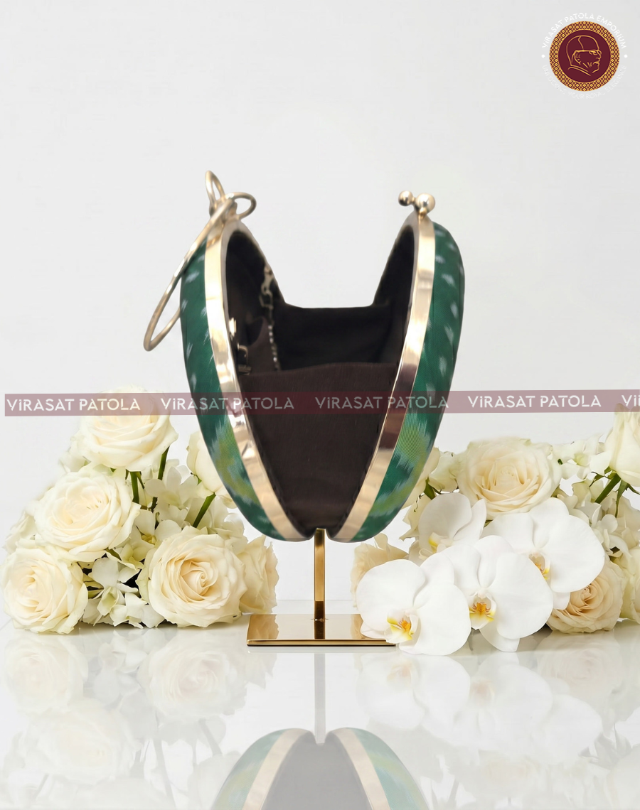 Green round clutch with gold trim, open black interior lining