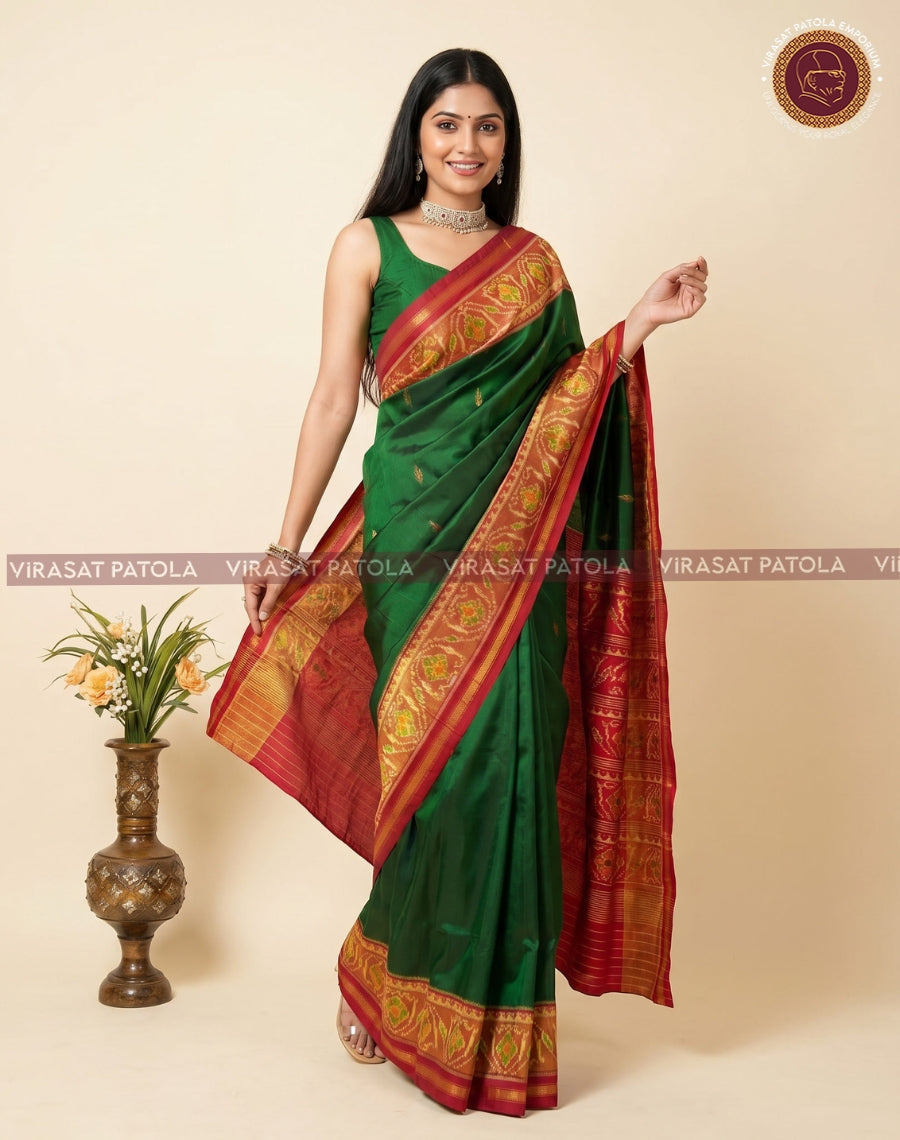 Green saree with maroon-red pallu and gold patterned border, styled on model.