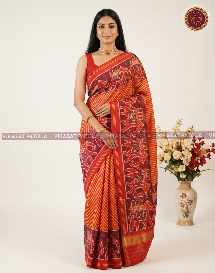 Rust-orange Patola saree with maroon panel and temple-style geometric motifs on pallu