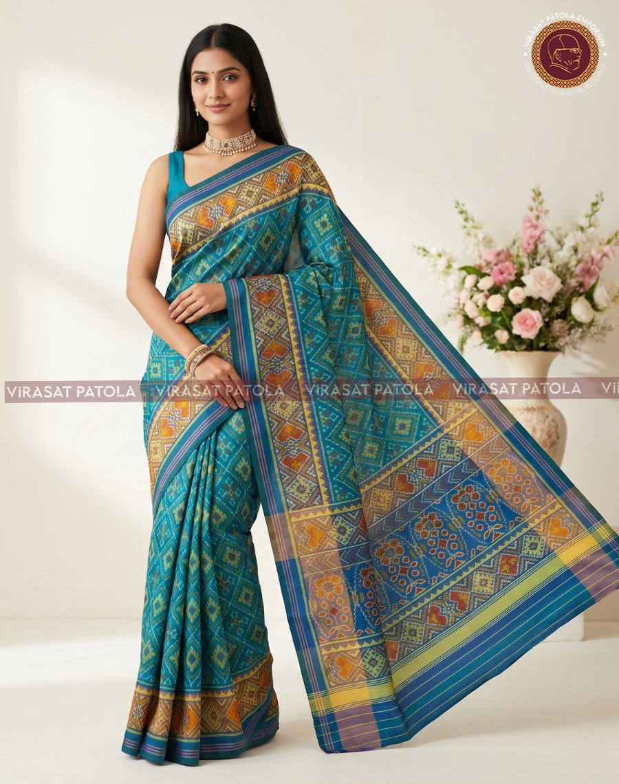 Sky blue patola saree with orange motifs and navy-blue striped border on pallu