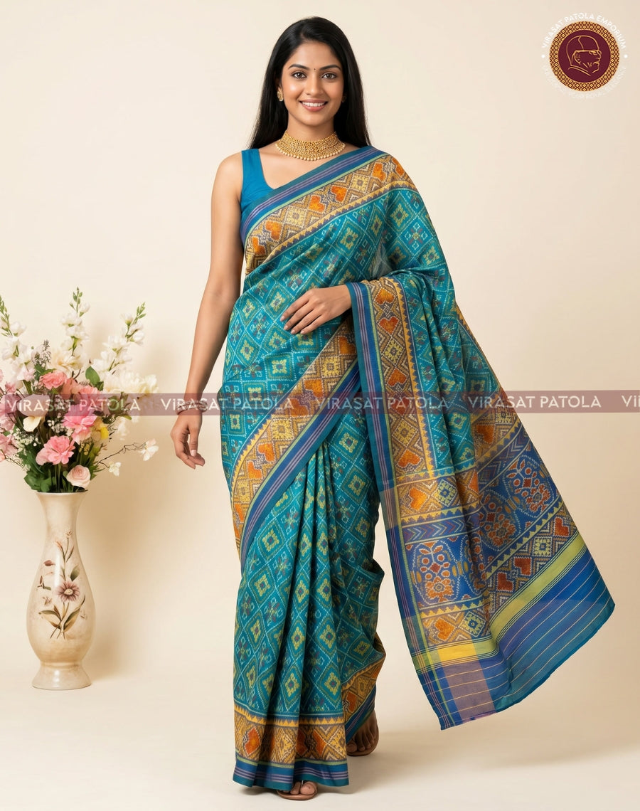 Sky blue patola saree with orange-gold geometric borders and detailed pallu