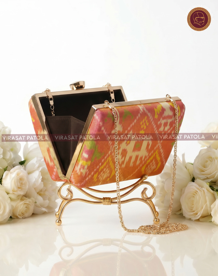 Nari Kunjar patola clutch, open top with black lining, gold chain and ring clasp