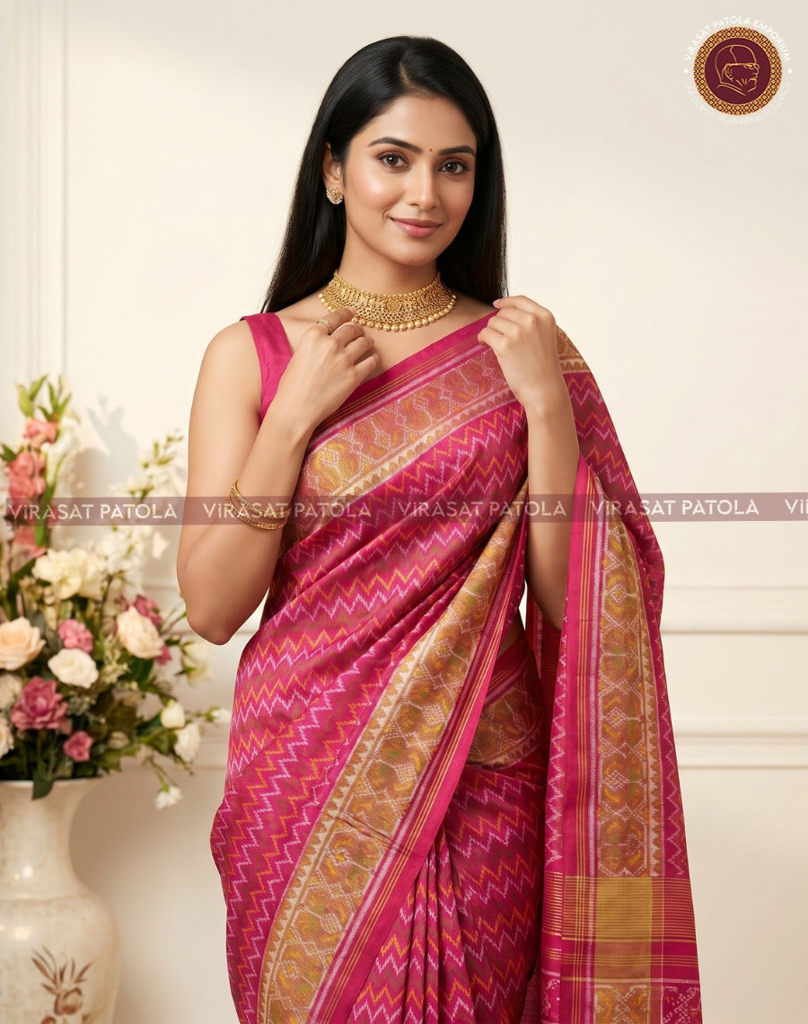 Magenta-pink Patola sari with zigzag laheriya motifs and wide gold woven border