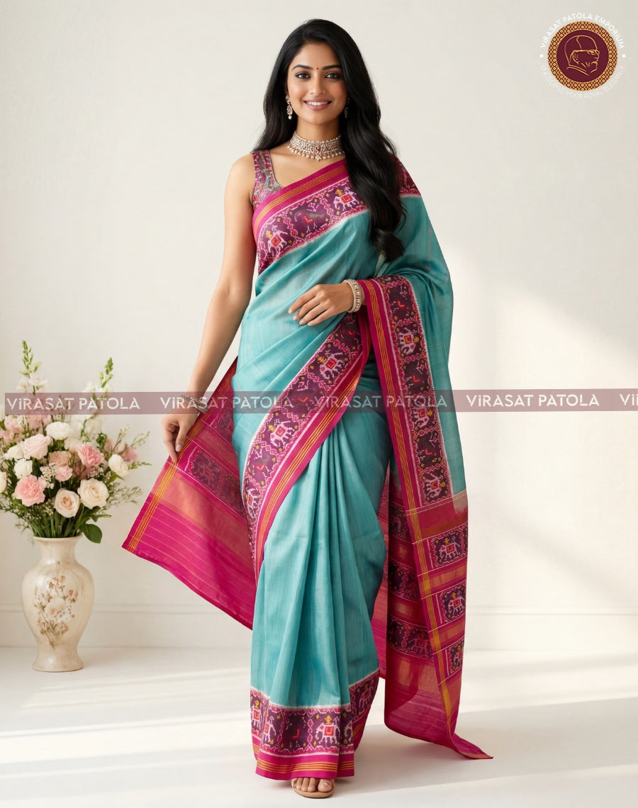 Teal traditional patola saree with magenta-pink border and patterned pallu