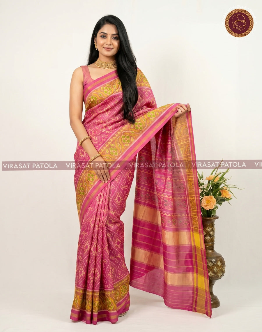 Pink traditional patola saree with zari-style border and repeating geometric motif pallu