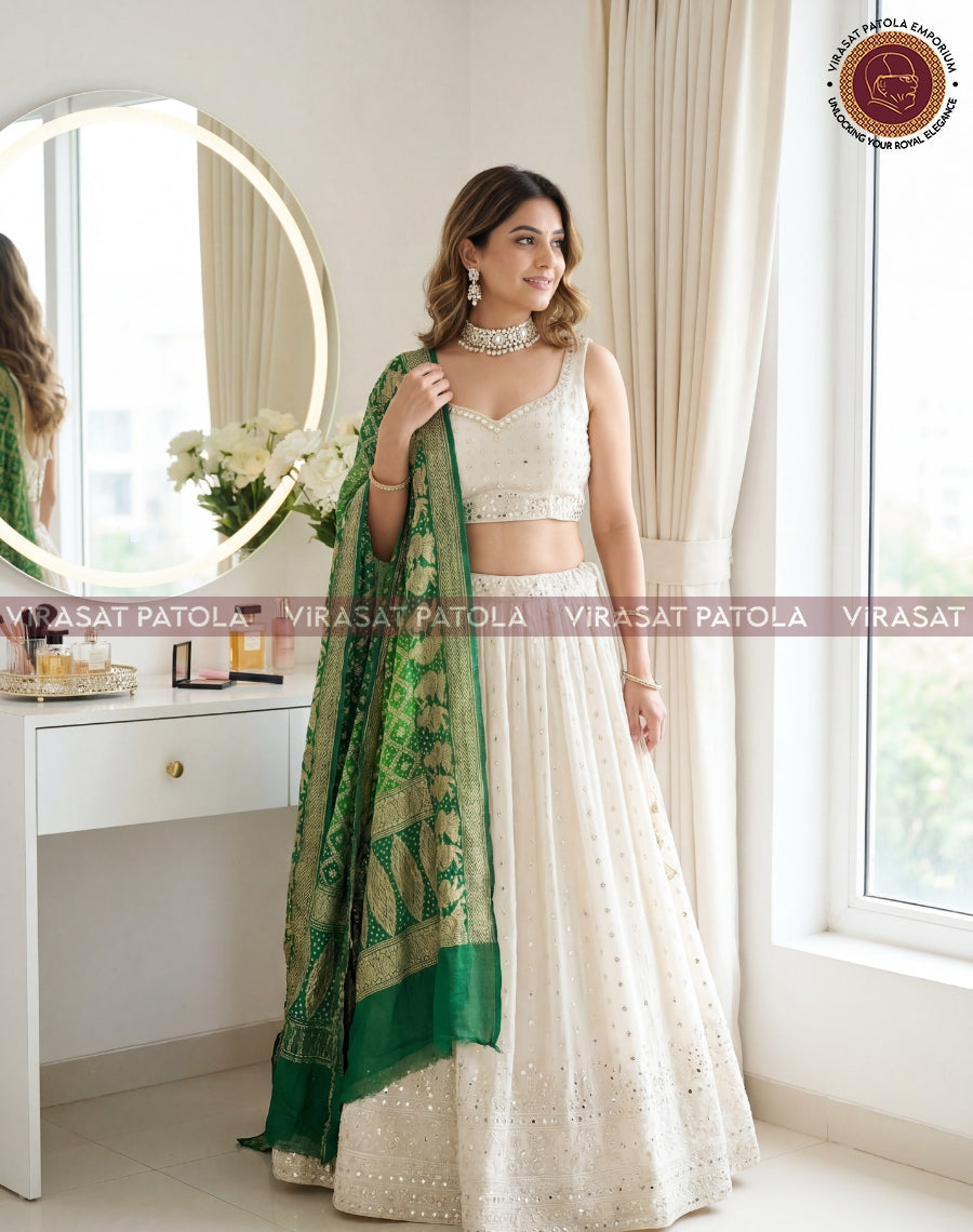 Green bandhani dupatta with gold patterned border, styled on one side