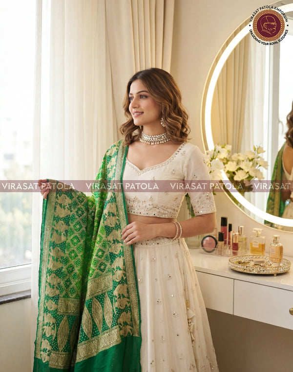 Green bandhani dupatta with ornate gold border, draped over the shoulder