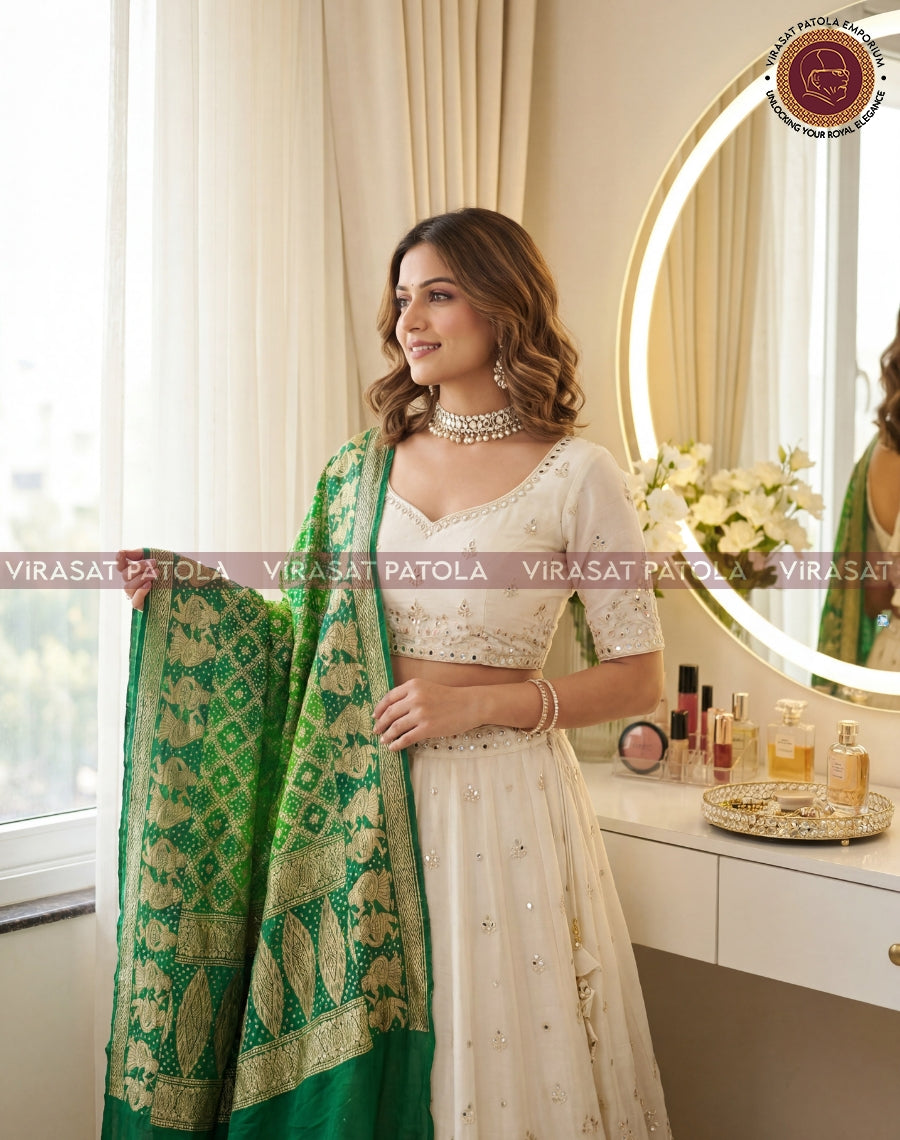 Green bandhani dupatta with ornate gold border, draped over the shoulder