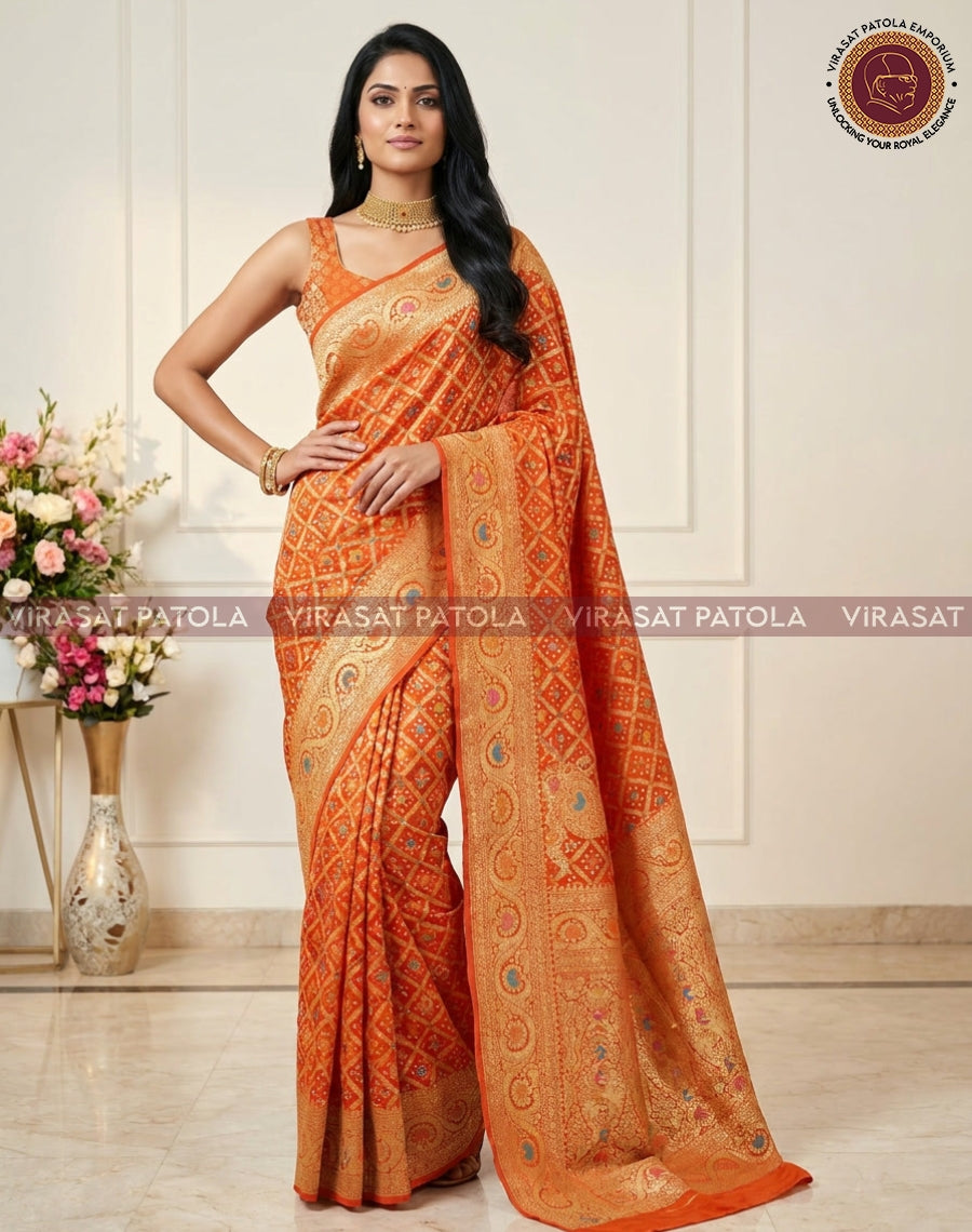 Orange georgette saree, patterned with bandhani motifs and wide cream-gold border
