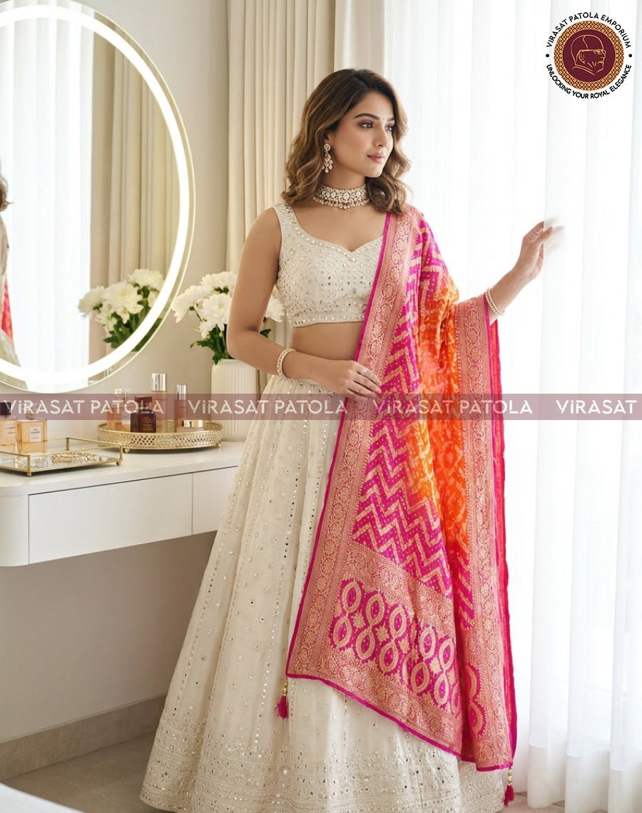 Pink-orange bandhani dupatta with ornate border, draped over shoulder