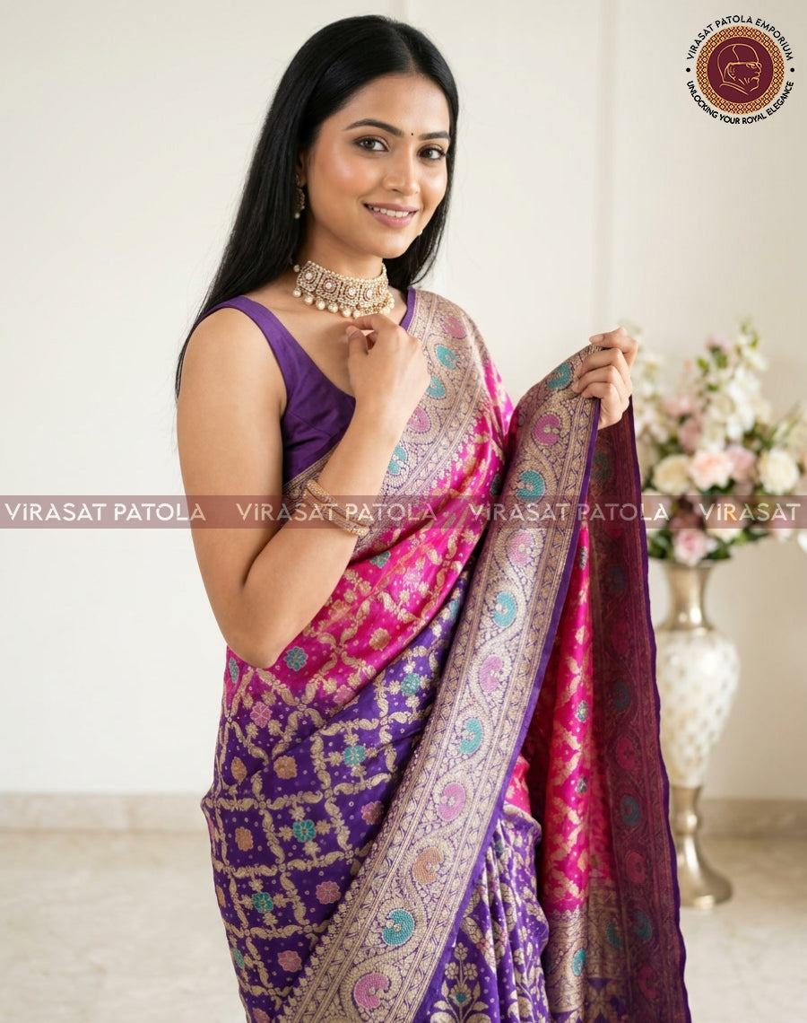 Bandhani saree featuring deep purple body, bright pink accents, and ornate paisley border