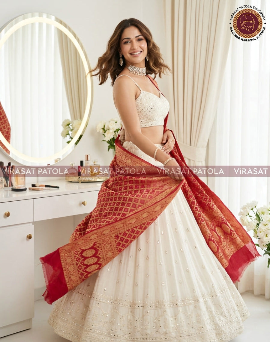 Red bandhani dupatta with gold border, flowing drape over the arm