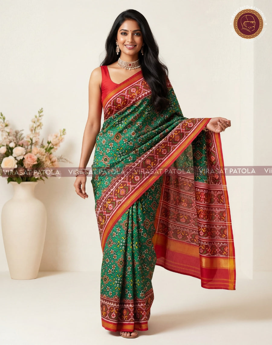 Red and green patola saree drape with wide maroon border and geometric motifs