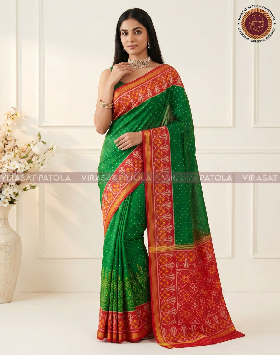 Green traditional patola saree featuring red patterned border and gold edge