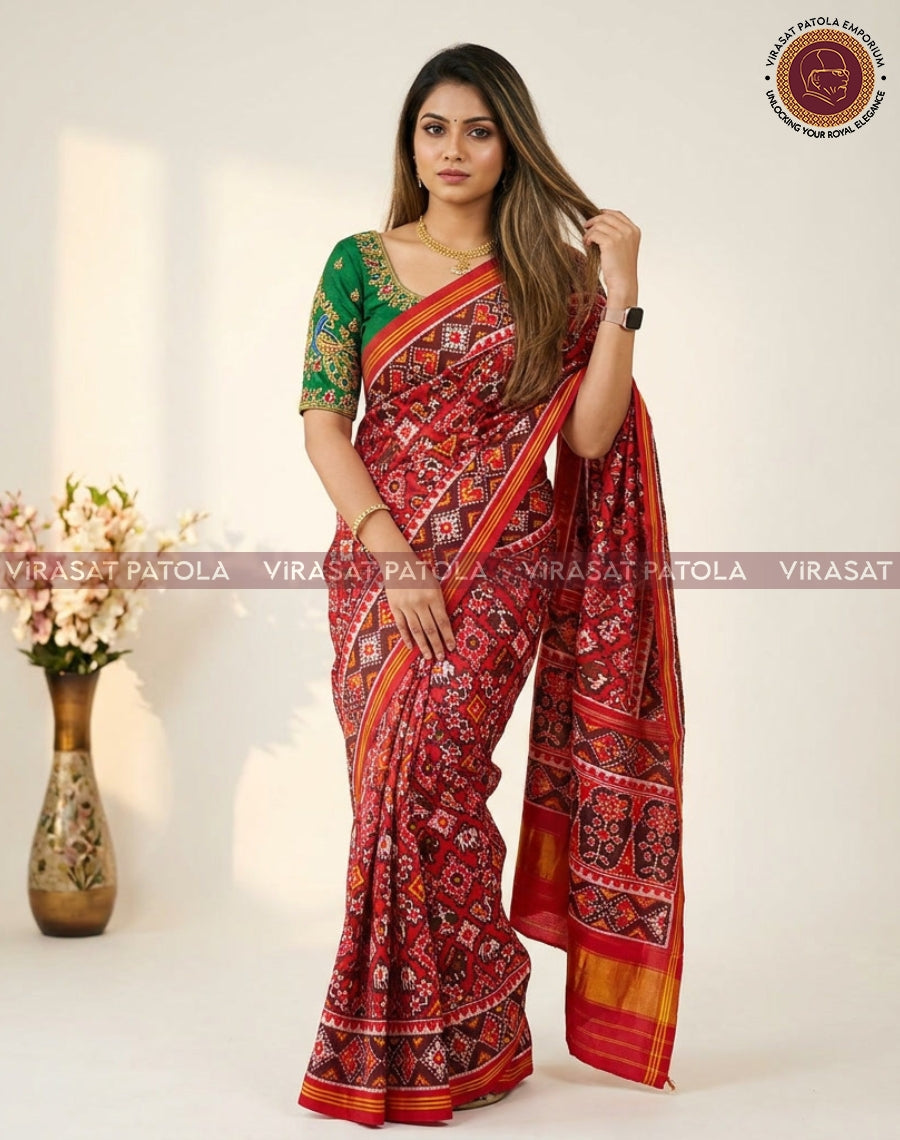 Red patola saree with multicolor diamond motifs, green blouse, golden border