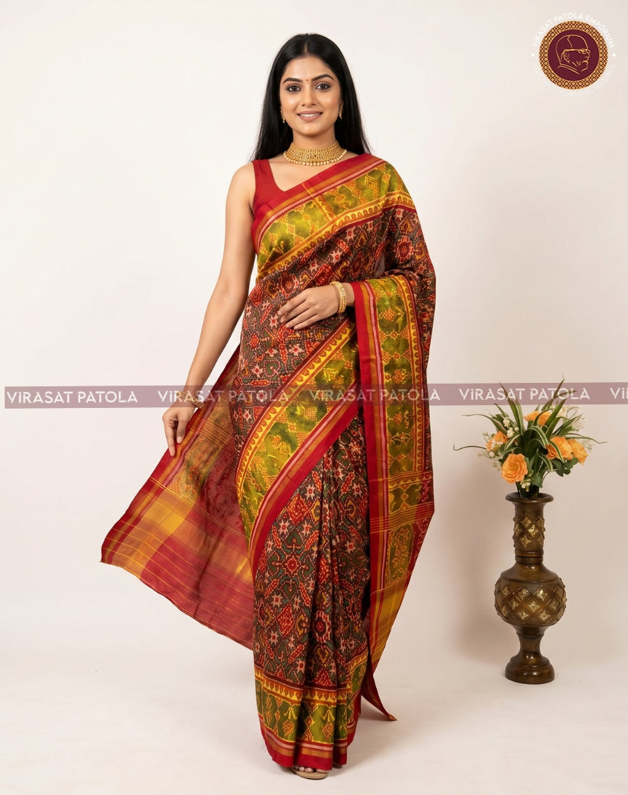 Maroon patola saree drape with contrast border and green-gold geometric checks