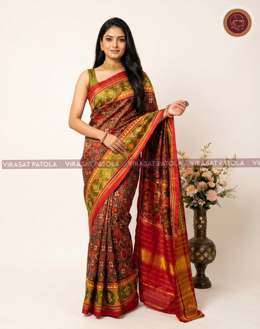 Maroon traditional patola saree with gold-green motifs, checkered border, and pallu