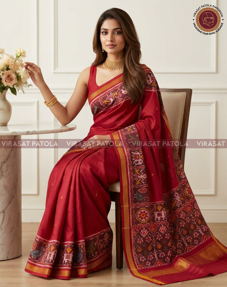 Maroon traditional saree with woven motifs, gold-trimmed pallu and striped border