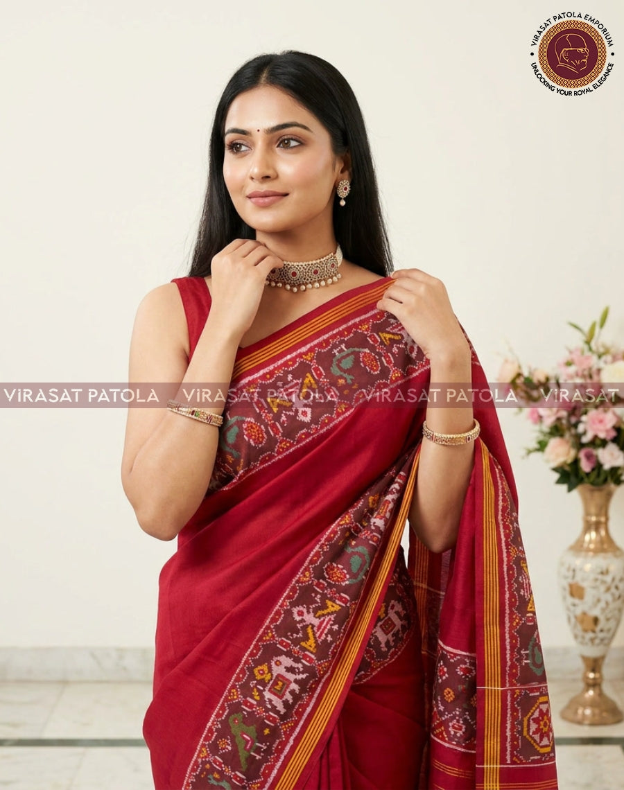 Maroon saree with rich patterned panel, multicolor border and pleated drape