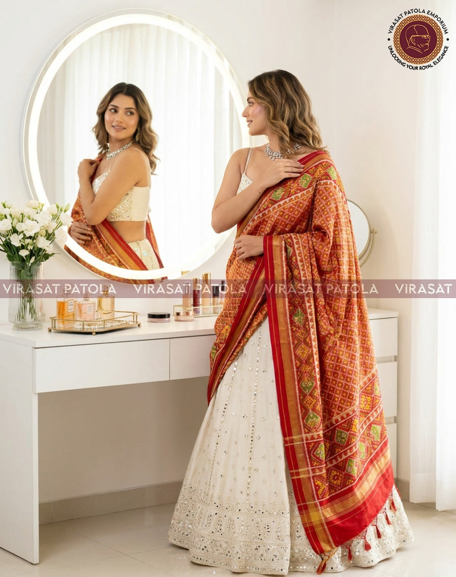 Red-orange tissue dupatta with green pattern border and gold accents