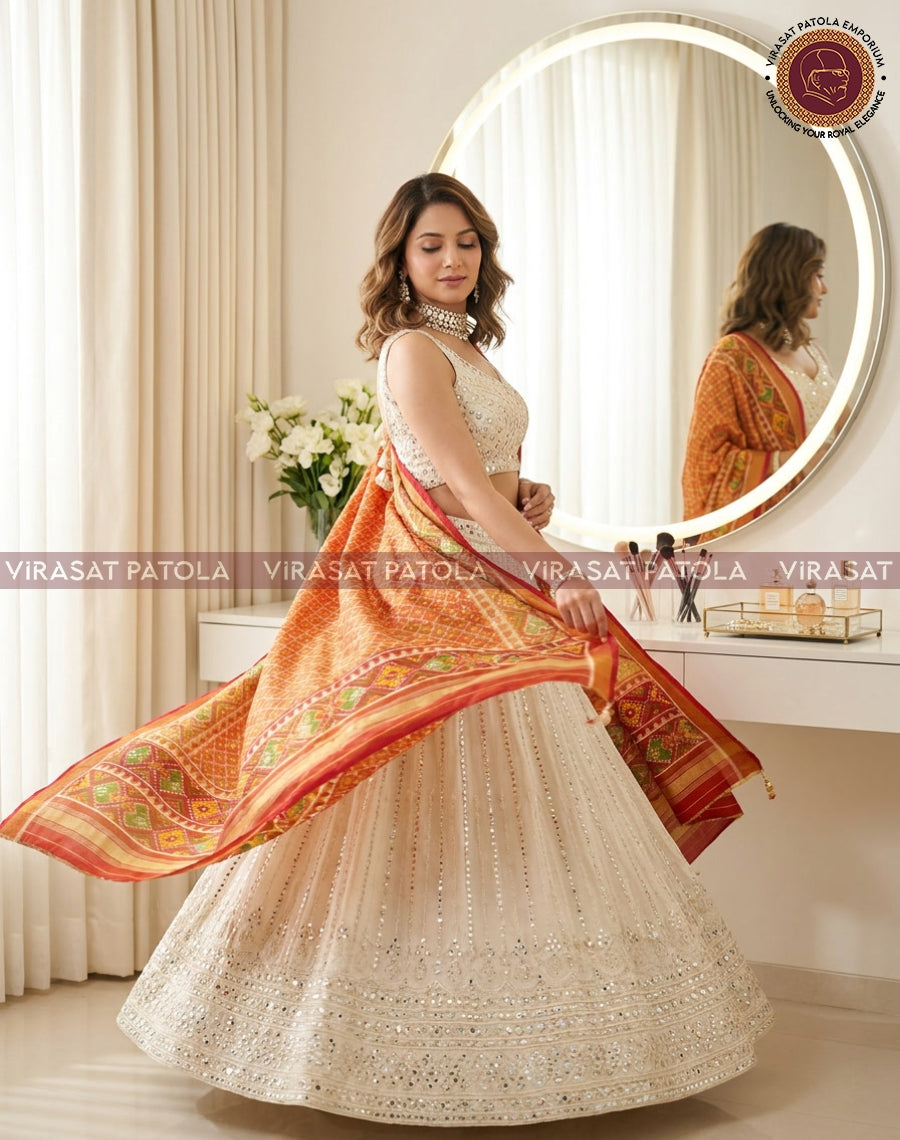 Rust red tissue dupatta with green motif trim and flowing gold-edged border