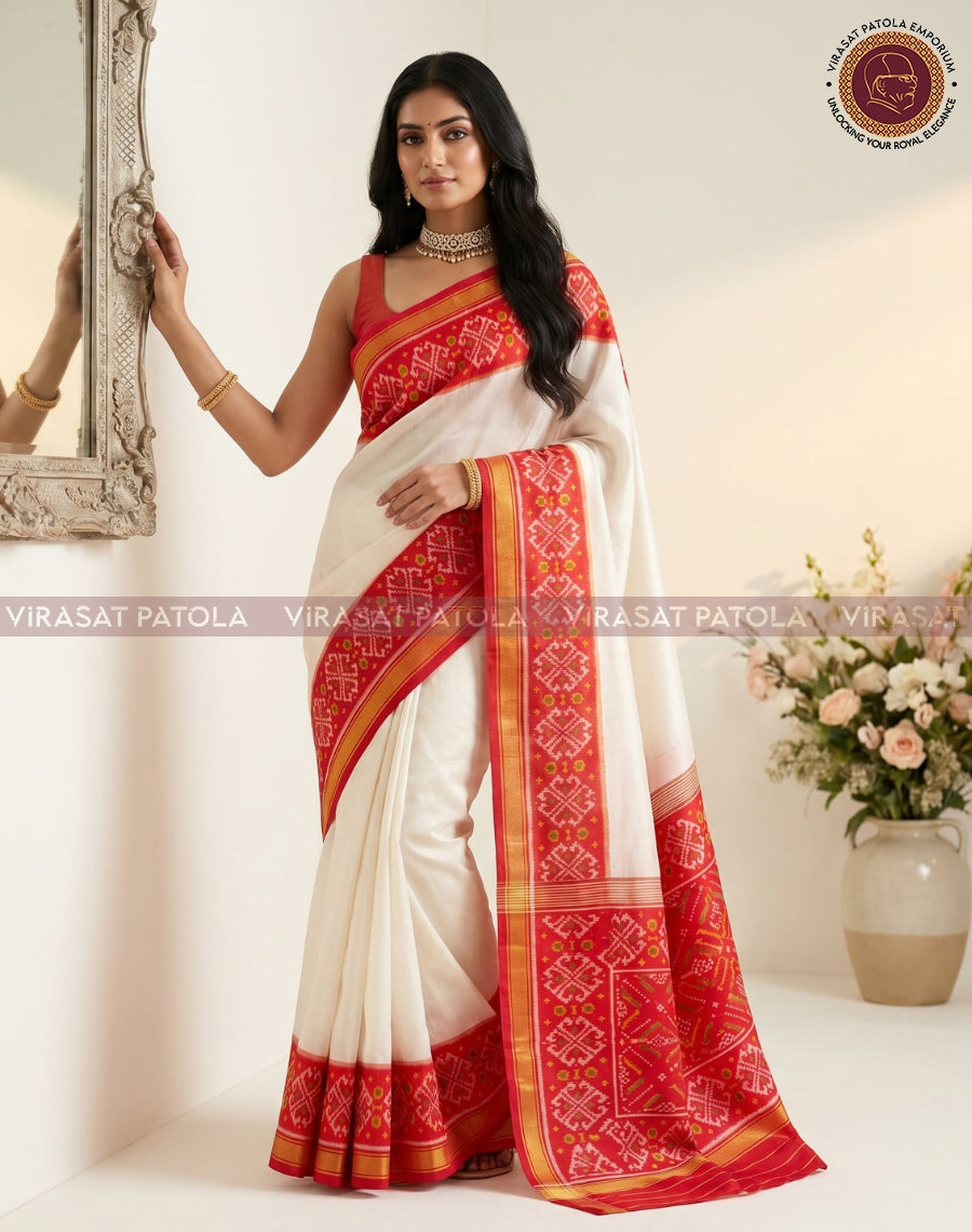 White saree with red traditional Patola border and gold-yellow trim