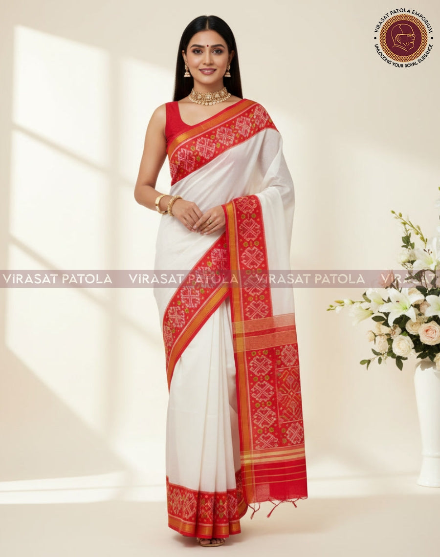 White traditional Patola saree drape with red patterned pallu and gold border