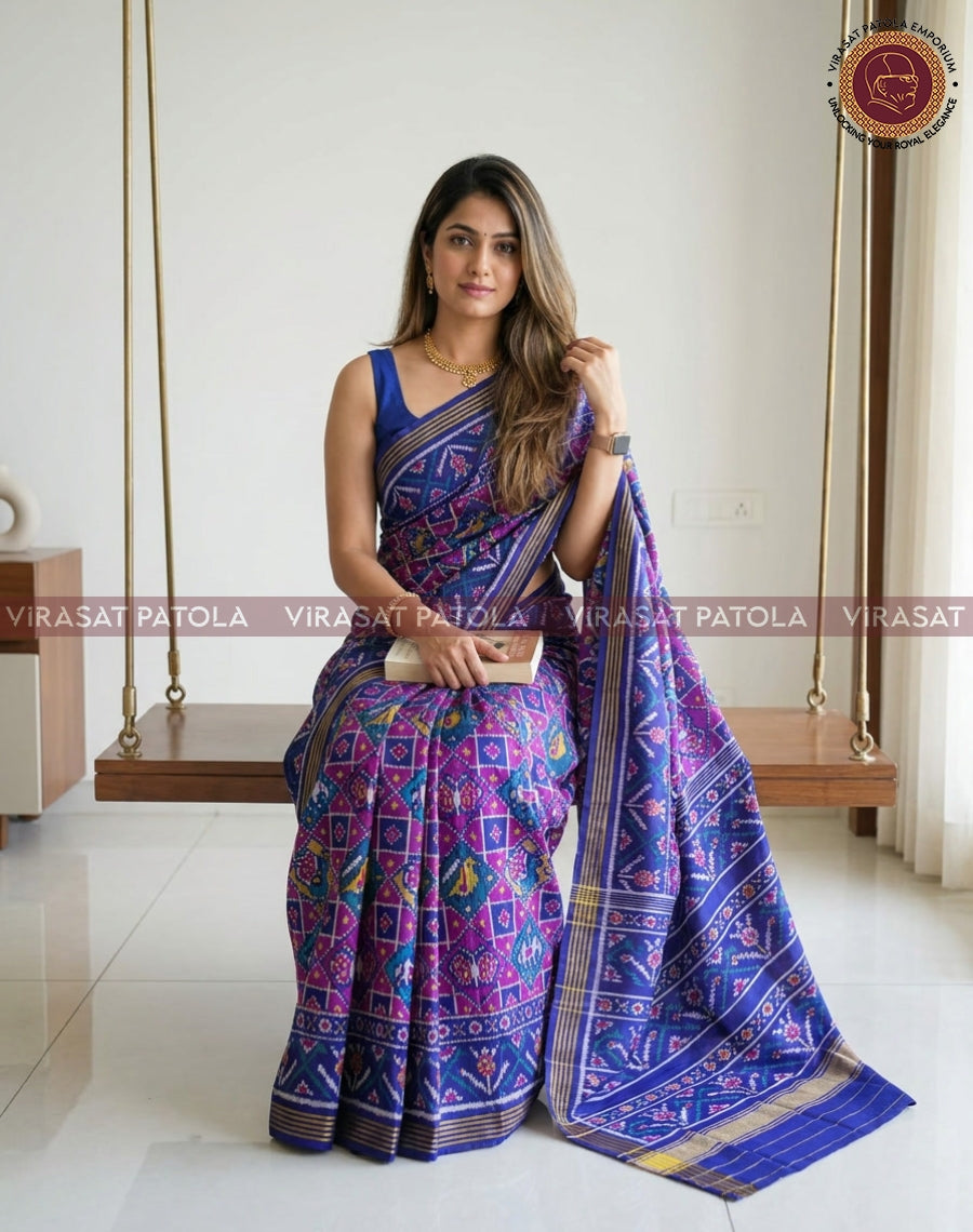 Royal blue traditional patola saree with magenta geometric motifs and gold border