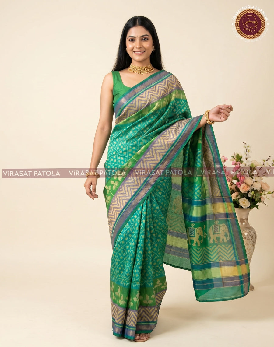 Fancy patola saree, green drape with beige ikat-like pattern and teal-gold border