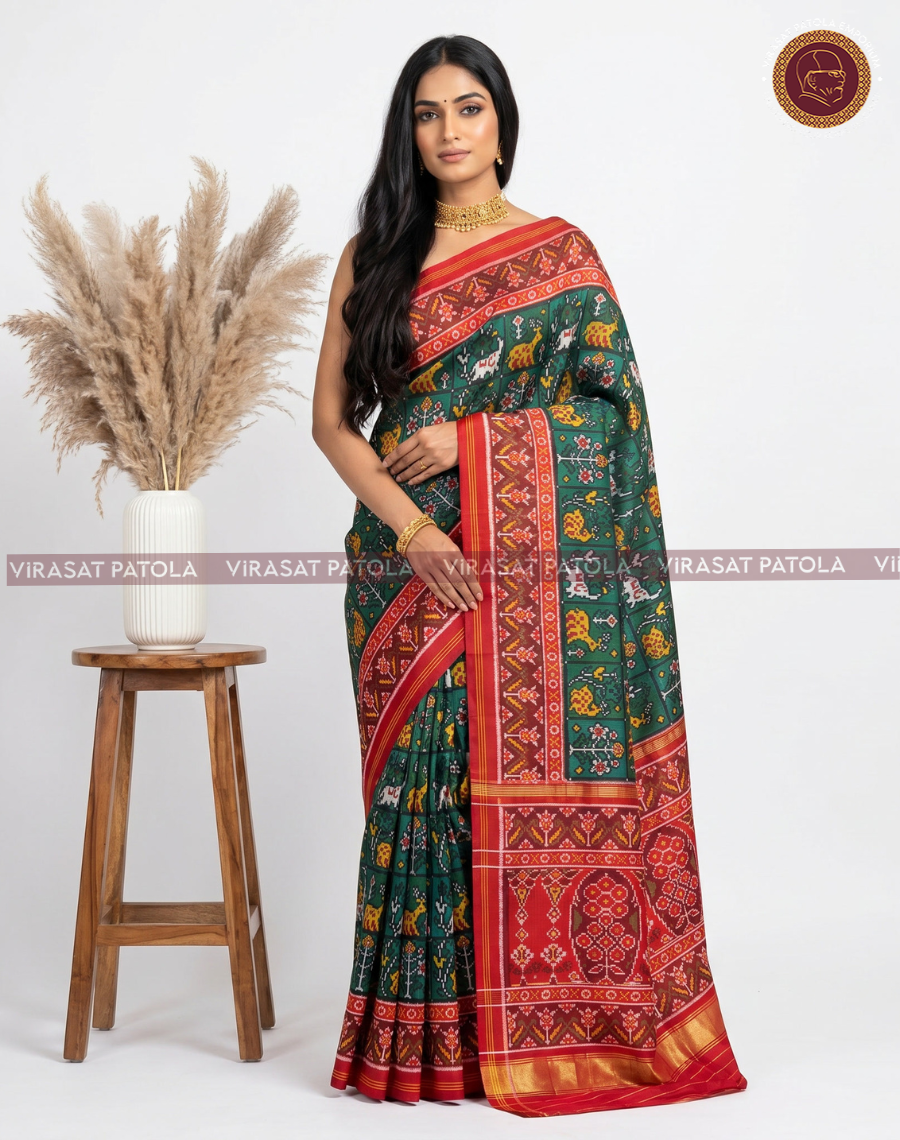 Traditional green saree with red-gold border and panel patola motifs