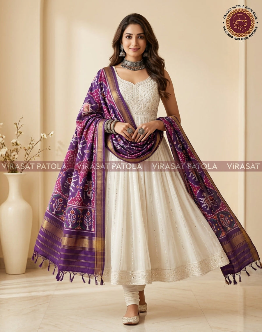 Royal blue and magenta patola dupatta draped over shoulder with gold border